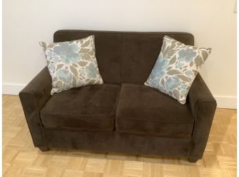Brown Cushioned Love Seat With Throw Pillows