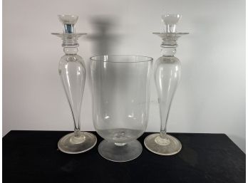 TWO LARGE GLASS CANDLESTICKS AND A LARGE GLASS FOOTED VASE