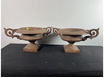 A PAIR OF CAST IRON URNS