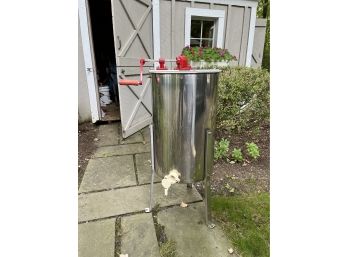 A Stainless Steel Honey Extractor And Necessary Accessories