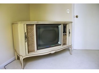 A Retro Motorola Television Console Built Into Drexel Wooden Cabinet With Sliding Doors