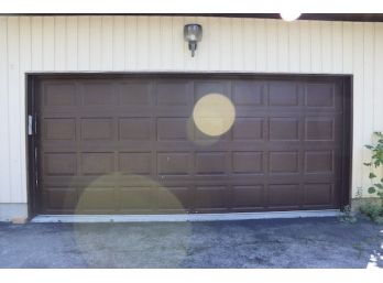 A Double Garage Door With Newer Overhead Opener