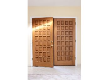 A Pair Of Multi Paneled Solid Wood Entry Doors