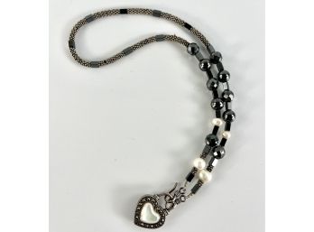 A Beaded Necklace With Sterling Silver Heart Pendant And Beads