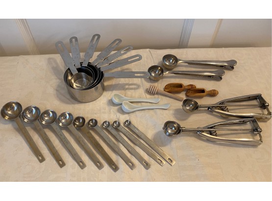 A Mixed Lot Of Measuring Cups, Spoons, Honey Dipper & More