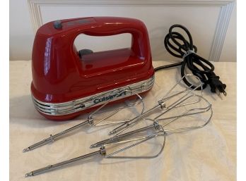 A Red CUISINART Hand Mixer With Four Beaters