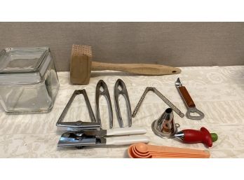 A Mixed Lot Of Kitchen Tools - Meat Tenderizer, Nut Crackers, Measuring Spoons & More