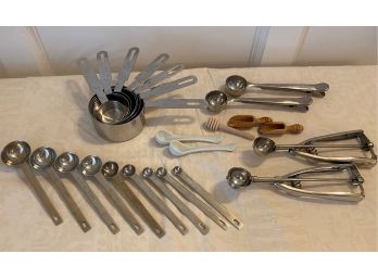 A Mixed Lot Of Measuring Cups, Spoons, Honey Dipper & More