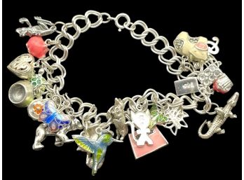 Sterling Silver Chain Linked Bracelet With Over Twenty Silver Charms.  7' Long