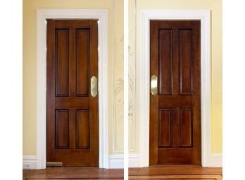 A Pair Of Paneled Mahogany Doors With Brass Push Plates