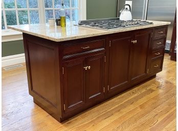 A Mahogany Kitchen Island With Granite Counters And Themador Gas Range - Counter