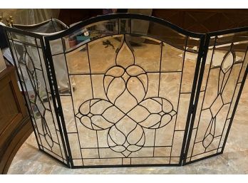 A Glass And Wrought Iron Fireplace Screen
