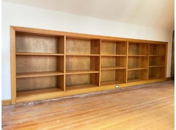 A Long Built In Solid Wood Bookshelf