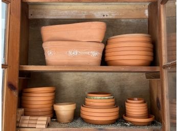 A Large Group Of Terra Cotta Plant Bases And Some Planters