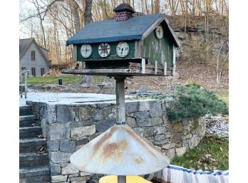 A Vintage Bird House On Steel Pole With Squirrel Guard