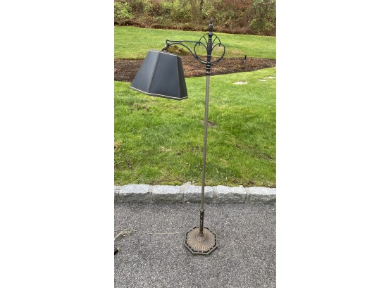 An Antique Metal Floor Lamp With Shade.