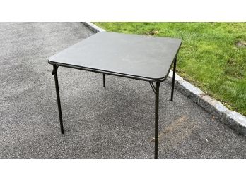 A Black Vinyl Foldable Card Table By Meco Made In USA