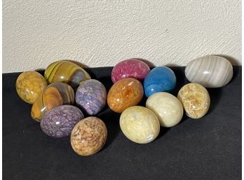 A COLLECTION OF POLISHED STONE EGGS
