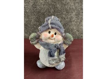 Cute Snowman In Knitted Mittens Scarf And Hat