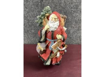 Santa Carrying Christmas Tree Figurine