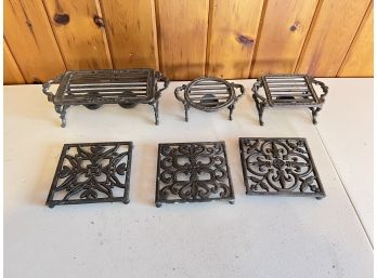 3 Cast Iron Warmers And 3 Aluminum Trivets