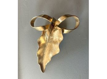 Massive Gold Tone Pin With A Leaf Below A Bow