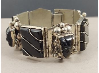 VINTAGE MEXICAN ALPACA SILVER ONYX AND HAWKS EYE STONE FACES BRACLET