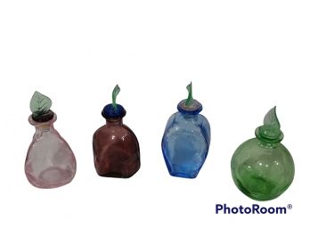 LOT OF 4 COLORFUL PERFUME BOTTLES WITH LEAF TOPPERS