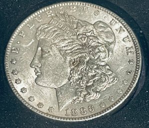 1886 MORGAN SILVER DOLLAR COIN- AU- IN PLASTIC CASE