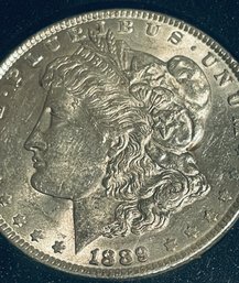 1889 MORGAN SILVER DOLLAR COIN- AU - IN PLASTIC CASE