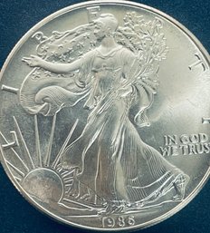 1986 SILVER AMERICAN EAGLE ONE OZT 99.9 PERCENT FINE SILVER ROUND - TONED
