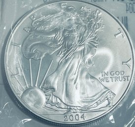 2004 SILVER AMERICAN EAGLE COIN -  1 OZT. .999 FINE SILVER - IN SEALED PLASTIC