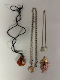 Group Of Necklaces And A Pendant: Satin Cord With Amber Glass, Faux Quartz & Locket Necklace With Fish Pendant