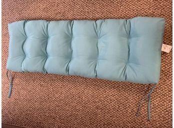 Indoor Outdoor Cushion In Cheerful Teal / Blue Color With Two String Ties - Measures  51 X 18 X 4'.