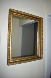 Hallway Mirror With A Gold Colored Frame