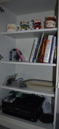 Noritake Stoneware Casserole Dish, Epsom Printer, Cookbooks, Holiday Mugs And Misc Cabinet Items (far Left)
