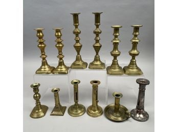 Group Of Twelve American Brass Push-Up Candlesticks And A Sheffield Plate Example