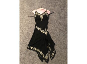 CACHE SIZE 4, SILK BLACK DRESS WITH GOLD EMBROIDERED FLOWERS, HANDKERCHIEF HEM-GB10