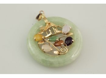 (D11) JADE/JADEITE WITH 14KT GOLD AND ASSORTED GEMS PENDANT-MEAURES 1 1/4' AROUND-5.9 DWT