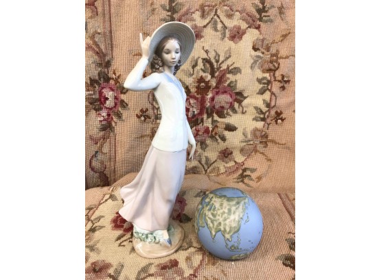 LOT OF 2 LLADRO. LADY WITH HAT APPROX 12 INCHES TALL AND 4 INCH GLOBE
