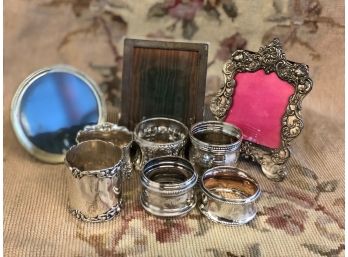 LOT OF 6 STERLING SILVER NAPKIN RINGS AND 3 PICTURE FRAMES.