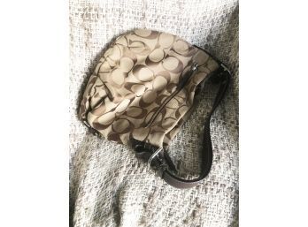 (62) COACH MONOGRAM TAN AND BROWN OVER THE SHOULDER AND ZIPPERED HANDBAG