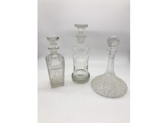 (139) LOT OF THREE VINTAGE CRYSTAL DECANTERS WITH STOPPERS - 10' - 13'