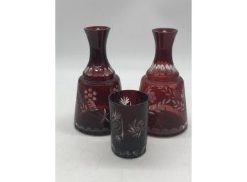 (147) TWO VINTAGE CUT RUBY GLASS DECANTERS & ONE GLASS TUMBLER
