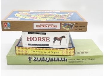 (73) LOT OF FOUR UN-OPENED GAMES - BACKGAMMON, ORIGAMI, HORSE & WOOD MAP PUZZLE