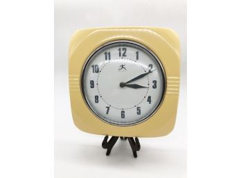 (67) YELLOW PLASTIC WALL CLOCK BY INFINITY - BATTERY OPERATED
