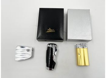 (lOT 41) LOT OF 3 BUTANE LIGHTERS-RONSON NO CASE WORKS-NIBO W/CASE WORKS-UNKNOWN W/CASE NEEDS FUEL