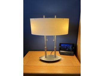(UP-J) MODERN PAIR OF BRUSHED STEEL BEDSIDE LAMPS WITH WHITE OVAL SHADES - 19' TALL, 12' WIDE