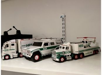 (RR) LOT OF SEVEN VINTAGE HESS TRUCKS WITH COPTERS & PLANES & THREE SMALL VEHICLES