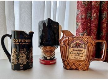 (DR-37) 3 VINTAGE CERAMIC ADVERTISING PITCHERS - '100 PIPERS, SEAGRAM CROWN ROYAL & CANADIAN WHISKEY' - 6'-10'